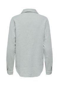 Chemise à manches longues gris clair en tissu texturé, col classique et poignets boutonnés, vue de dos sur un fond blanc.