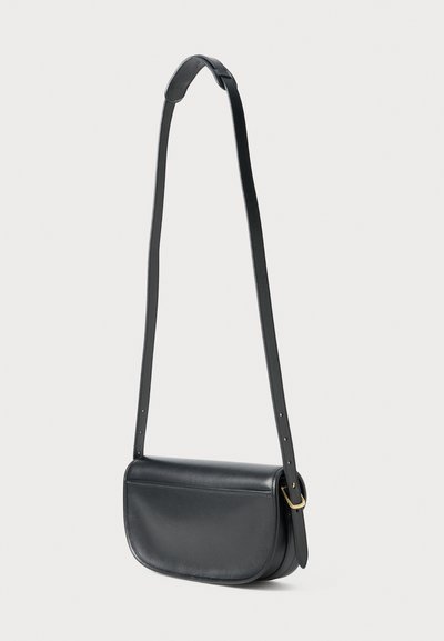Black leather crossbody bag with a rounded, structured shape, adjustable strap, and a subtle gold hardware accent. Smooth texture.