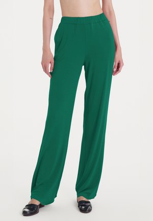 Pantaloni verde chiaro a gamba larga con vita elastica, realizzati in tessuto liscio e leggero. Presentano tasche laterali e una vestibilità comoda.