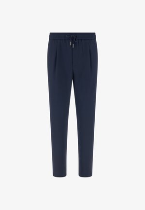 Granatowe zwężane spodnie z elastycznym paskiem i sznurkiem, plisami z przodu oraz luźnym krojem.