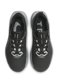Black athletic shoes with mesh upper, structured detailing, reflective accents, and black laces; features a textured sole and logo print inside.