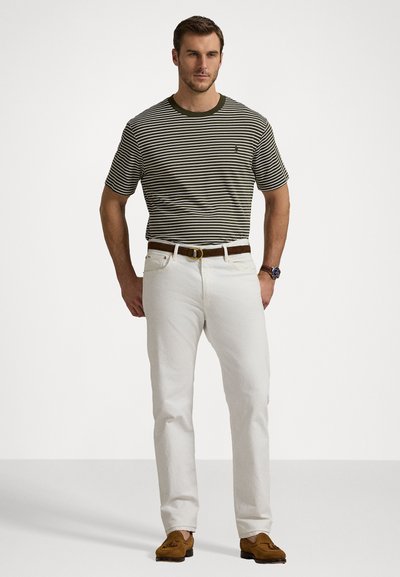 Striped short-sleeve shirt in olive green and white, paired with white jeans and a brown belt. Brown loafers complete the outfit.