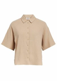 Chemise à manches courtes, boutonnée en beige clair, avec un tissu texturé et froissé et un col classique. Coupe décontractée et ample.