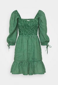 Zelené kostkované šaty s čtvercovým výstřihem, smockovaným tělem, nadýchanými rukávy se stahovacími šňůrkami a volánkovým lemem. Vyrobeno z lehkého materiálu.
