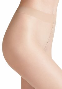 Collants beiges transparents avec une taille sans couture, texture lisse et design ajusté, offrant une couverture uniforme du teint de la peau et de subtils détails de couture.