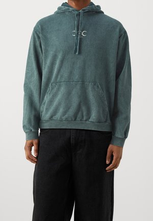 Teal, bomulds hoodie med en frontlomme, snor i hætten, ribbede manchetter og kant. Har et lille logo på brystet.