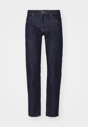 Dark blue denim jeans with straight cut, five-pocket design, contrasting yellow stitching, and a metal button closure at the waist.