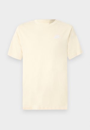 T-shirt en coton crème clair à manches courtes, col rond. Présente un petit logo Nike blanc sur le côté gauche de la poitrine.