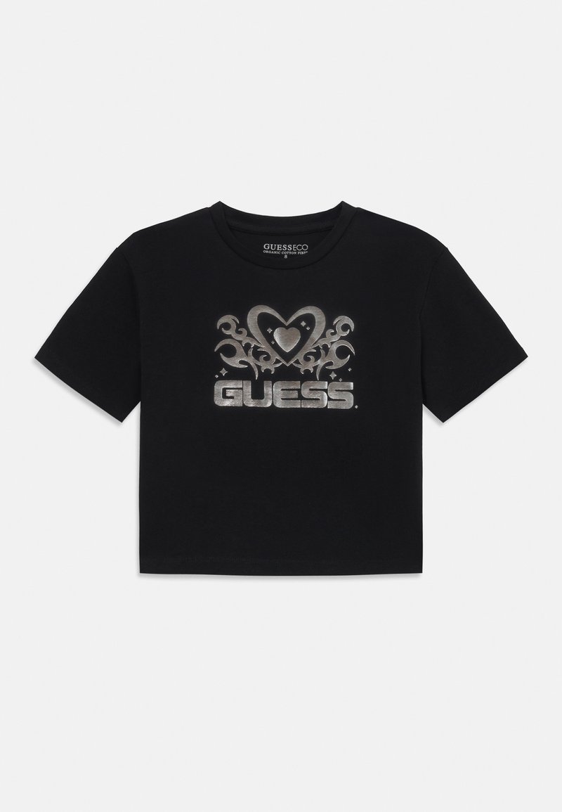 Svart kortärmad t-shirt i bomull, med ett silverhjärta och blommönster med "GUESS"-logotypen i fet stil i mitten.