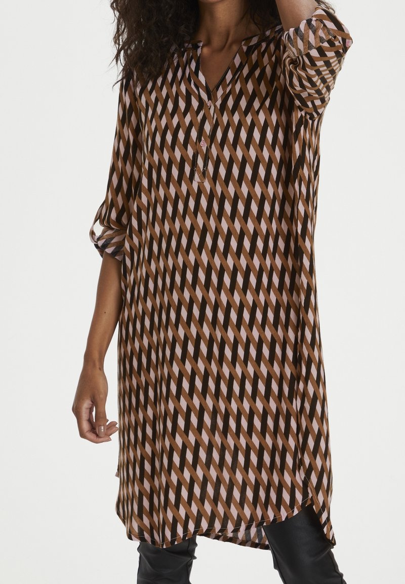 Brown and pink patterned long shirt with a v-neck, three-quarter sleeves, and a straight hem. Made from a lightweight, flowy material.