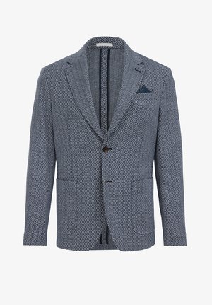 Blazer z vzorom houndstooth v námorníckej modrej a bielej farbe, s špicatým klopom, dvoma prednými vreckami a modrým vreckovým štvrtkom. Predné zapínanie na gombík.
