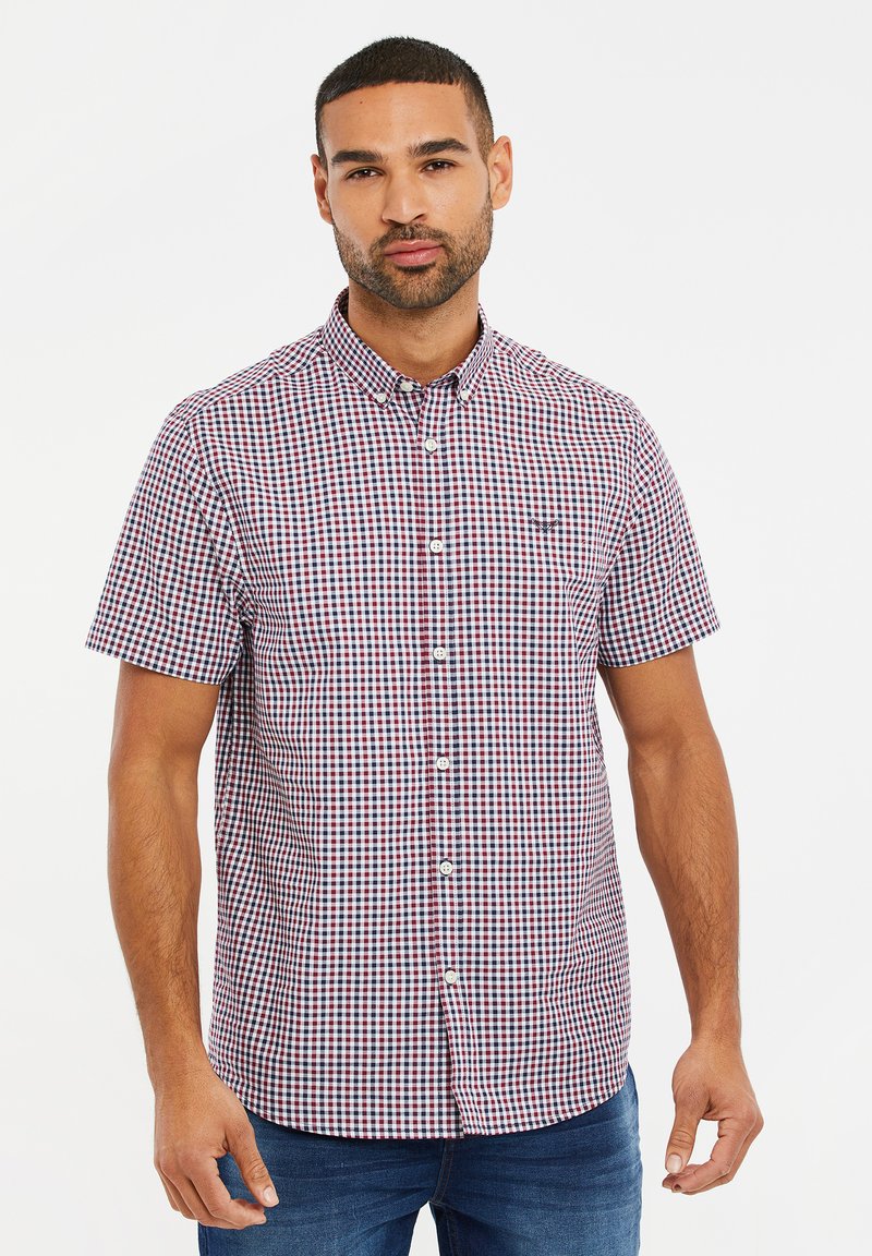 Kortebloesem met een ruitpatroon in blauw, rood en wit. Beschikt over een button-down kraag, knopen aan de voorkant en een subtiel logo op de borst.