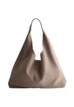 Beige suede hobo bag with a deep cutout handle. Soft texture and slouchy silhouette create a casual yet modern design. No visible hardware.