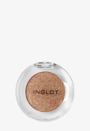 Palette ronde simple d'ombre à paupières bronze pailletée de la marque Inglot dans un boîtier en plastique transparent sur fond blanc.