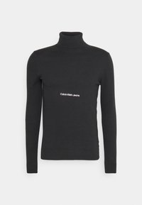 Maglione a collo alto di colore nero realizzato in un tessuto morbido. Presenta maniche lunghe e un piccolo logo bianco "Calvin Klein Jeans" sul petto.