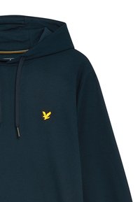 Felpa blu navy con cappuccio regolabile, caratterizzata da un logo di un uccello ricamato giallo sul petto e un tessuto morbido e texturizzato.