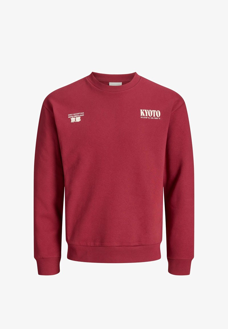 Rode katoenen sweatshirt met lange mouwen. Heeft witte tekstafbeeldingen: "KYOTO", coördinaten, en "ALLEN GOEDE VIBRATIES GEACCEPTEERD." Klassieke ronde hals.