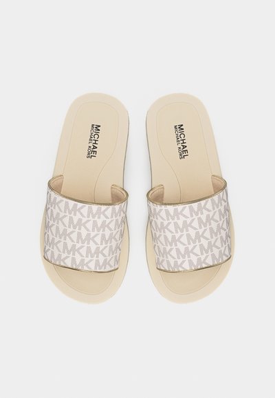 Μπεζ σανδάλια Michael Kors με φαρδιές λουράκια που φέρουν επαναλαμβανόμενο μοτίβο με το λογότυπο "MK", επίπεδη σόλα και επωνυμομένα πέλματα.