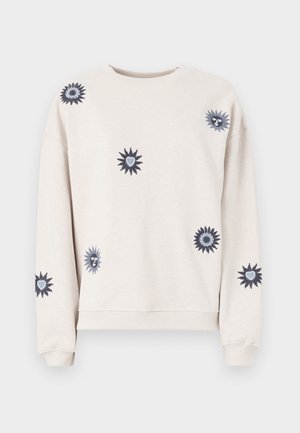 Sweatshirt di un beige chiaro realizzato in un tessuto morbido. Presenta vari motivi ricamati a forma di sole in blu scuro e argento su tutta la superficie.