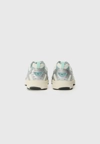 Sport shoes in light gray and mint green, featuring a breathable mesh upper, reflective accents, and a cushioned cream sole.