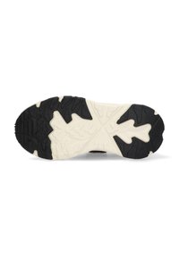 Suela de zapato de goma negra y crema con un patrón texturizado, con tracción y estabilidad gracias a sus tacos multidireccionales.