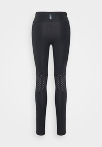 Leggings neri realizzati in materiale elastico, con vita alta, design elegante e dettagli a pois sulle gambe inferiori.