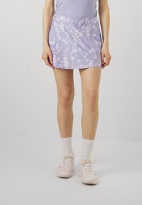 Purple tie-dye skirt made of soft, lightweight fabric, featuring a flared design and a smooth texture, paired with white athletic socks and shoes.