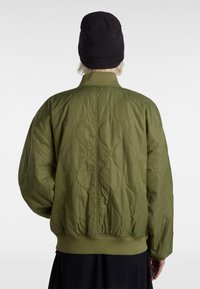 Quilted olive green bomber jacket with ribbed cuffs and hem, showcasing a smooth texture and prominent stitching pattern.