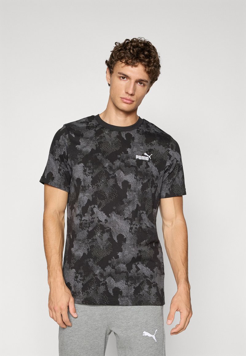 Zwart en grijs camouflage t-shirt met korte mouwen, ronde halslijn en Puma-logo op de bovenste linkerzijde. Zachte stoftextuur.