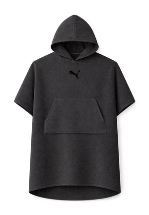 Man wearing a dark gray short-sleeve hooded towel poncho with kangaroo pocket and Puma logo, standing with hands in pockets.