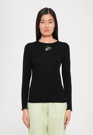 Black long-sleeve sweater with a scalloped neckline and green embroidery of leaves on the chest. Soft texture, fitted shape.