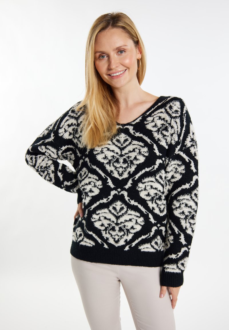 Pulover cu model alb și negru, de tip V, croială lejeră, cu mâneci lungi și manșete cu nervuri, având un design floral pe întreaga suprafață.