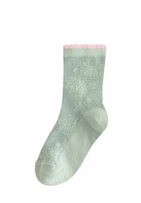 Grön stickad socka med ett rosa vågigt manschett, som har ett subtilt mönster. Materialet verkar mjukt med en andningsbar textur.