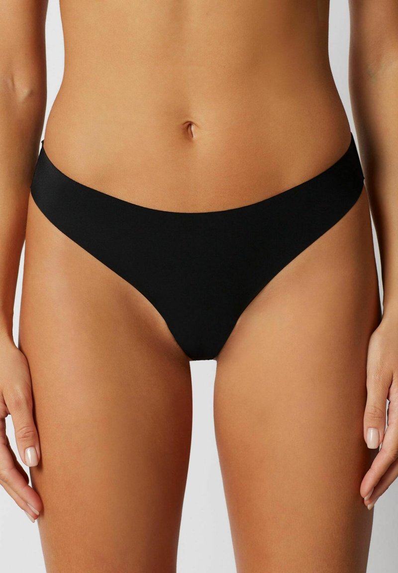 Schwarzer Tanga-Bikiniunterteil aus glattem Material, mit minimalistischem Design, niedriger Schnitt und ohne sichtbare Muster oder Hardware-Details.