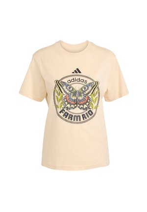 Krém színű pamut póló, pillangó grafikával és a "adidas FARM Rio" felirattal kör alakú dizájnban. Rövid ujjú, kerek nyakú.