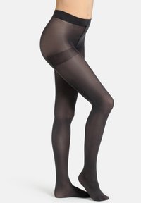 Collant neri opachi con una consistenza liscia, una cintura elastica ampia e un pannello semitrasparente a metà coscia.