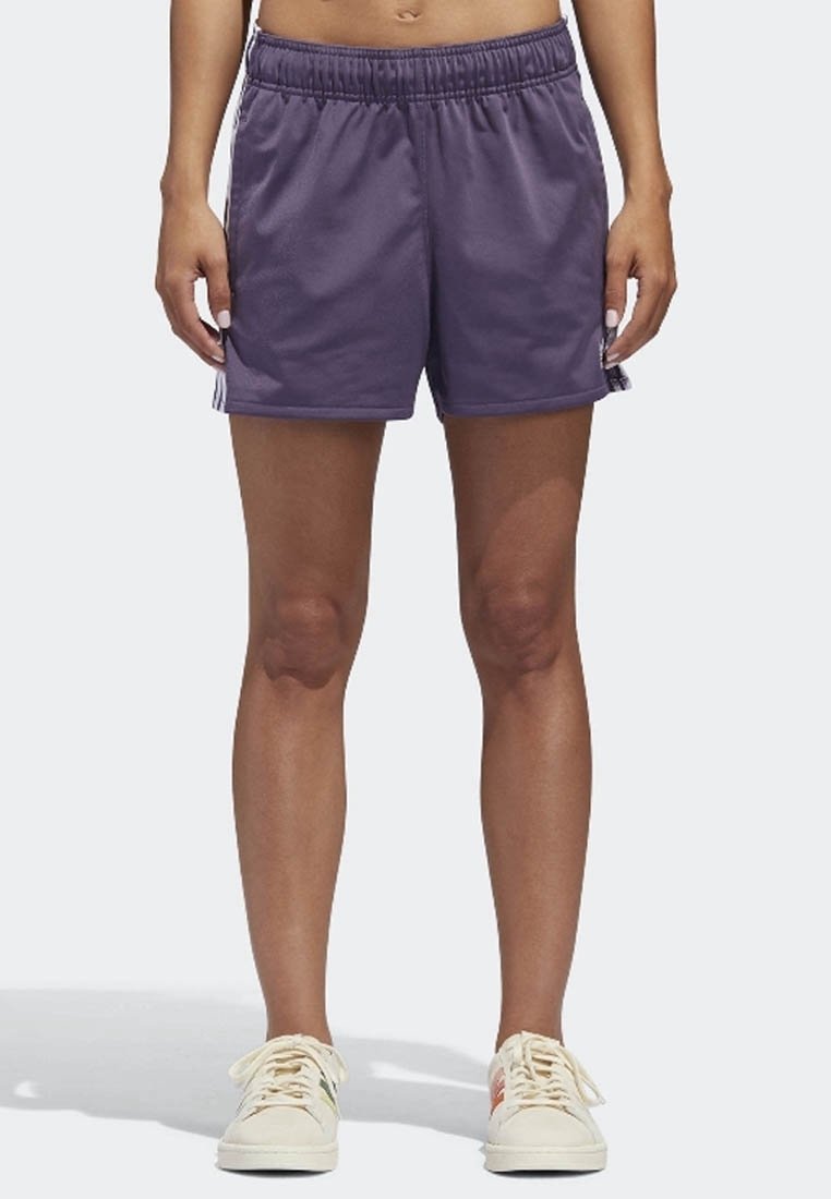 Purple athletic shorts with an elastic waistband, made from lightweight material. Features white stripes along the sides.