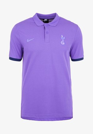 Polo violet Nike avec logo Tottenham Hotspur sur la poitrine, deux boutons et poignets de manches bleu marine foncé.