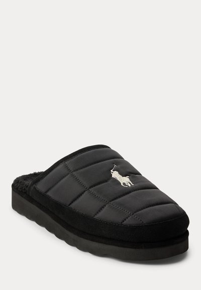 Black quilted slip-on slipper with thick sole and white embroidered polo player logo on top.