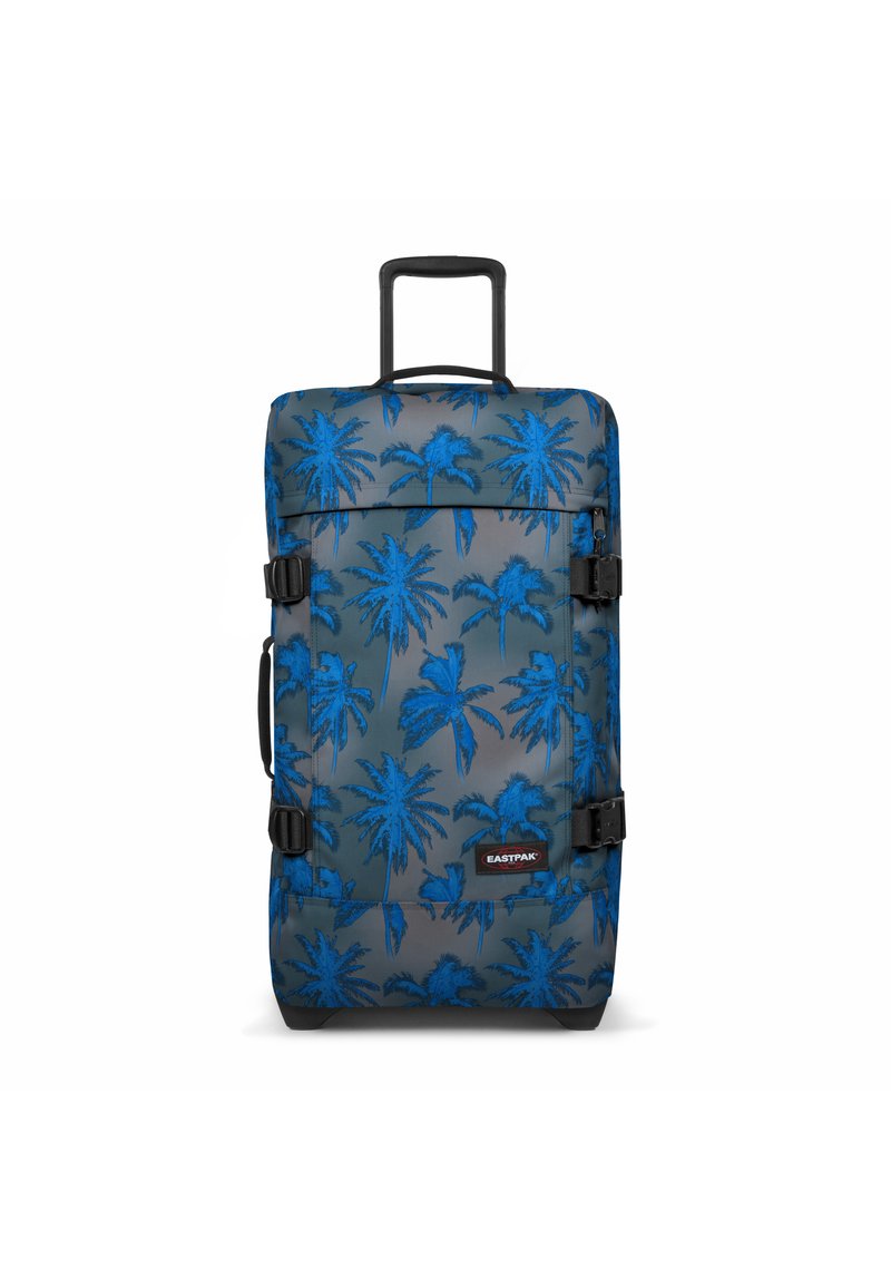 Maleta con patrón de palmera azul sobre tela gris, herrajes negros, asa superior y dos correas de compresión laterales.