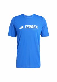 Maglietta sportiva blu a maniche corte realizzata in tessuto liscio con scollo rotondo; presenta un logo bianco "TERREX" sul davanti.