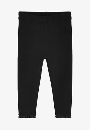 Leggings negros hechos de una tela suave y elástica. Tienen un diseño ajustado y un pequeño borde con volantes en el dobladillo inferior.
