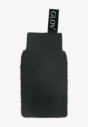 Gant exfoliant texturé noir avec un bracelet en tissu noir et une boucle étiquetée « GLOV » sur fond blanc.
