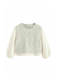 Pull en tricot avec un buste texturé gris clair et des motifs floraux brodés, présentant des manches bouffantes crème et un ourlet court.