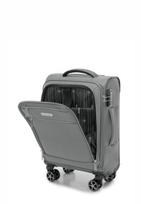 Hartschaliger grauer Koffer mit vier Rädern, einer Reißverschlusstasche vorne und einem geometrischen Textilinienmuster im Inneren. Griff oben für einfaches Tragen.