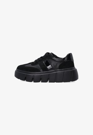 Black sneakers featuring a mix of suede and patent leather, with a chunky sole and textured accents on the upper. Laced design.