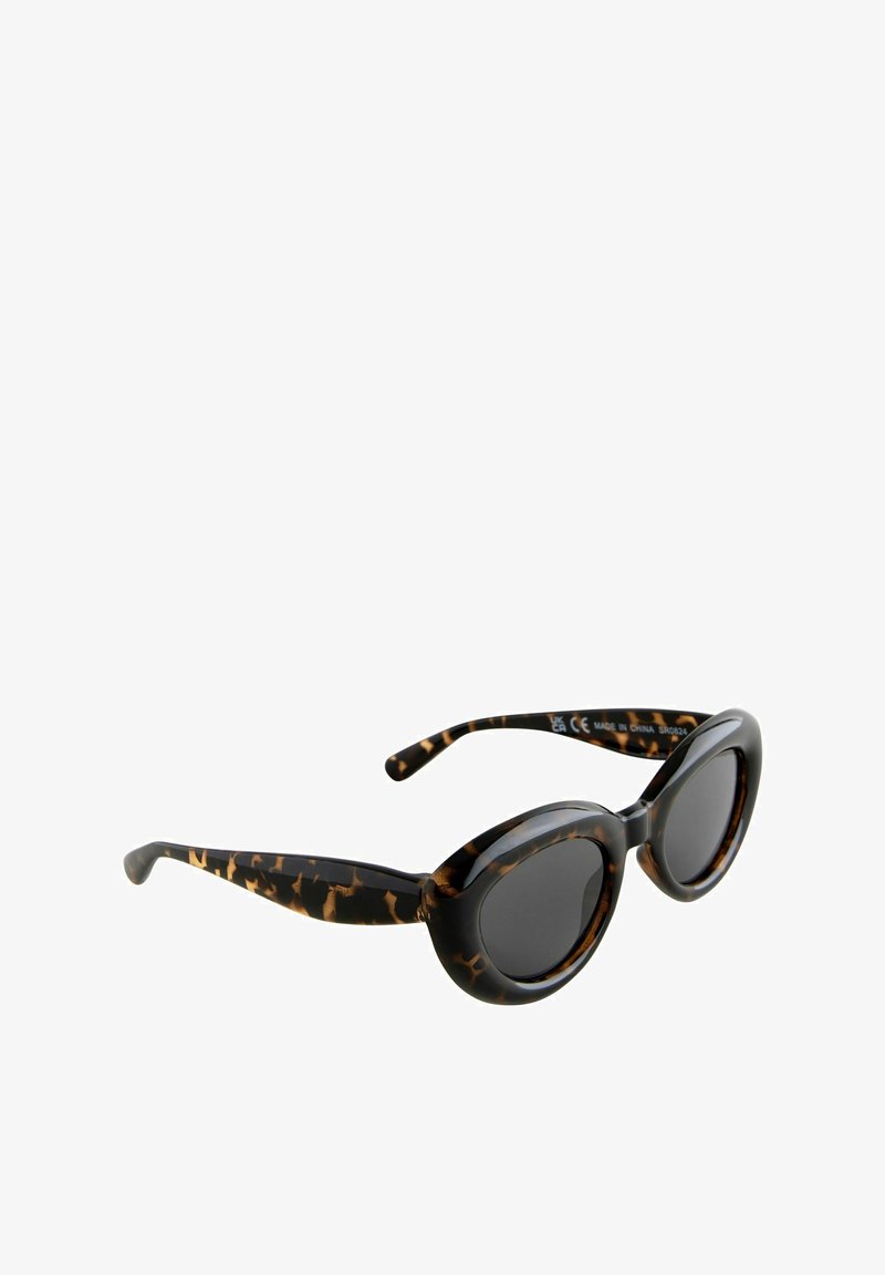 Lunettes de soleil rondes en écaille de tortue avec des verres noirs et une monture en plastique lisse. Temples arrondis et accents de motif subtils.