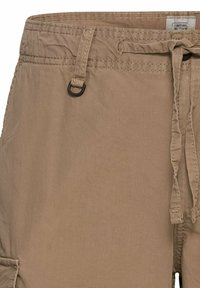 Beige cargo shorts with a drawstring waist, stitched details, a fabric loop accent, and side pockets. Made from lightweight material.