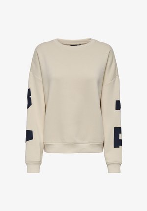 Beżowa bluza wykonana z miękkiej tkaniny, z okrągłym dekoltem, opuszczonymi ramionami oraz granatowymi nadrukami na obu rękawach.