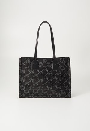 Zwarte tote bag met herhaaldelijk lijntekening gezichtenpatroon, met stevige zwarte handvatten en een rechthoekige vorm, gemaakt van duurzaam materiaal.